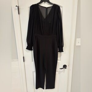 Express black V-neck long-sleeved jumpsuit with pockets.